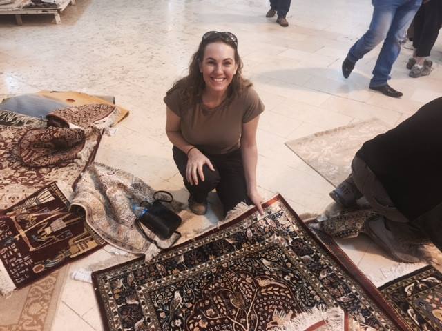 Woman With Rugs