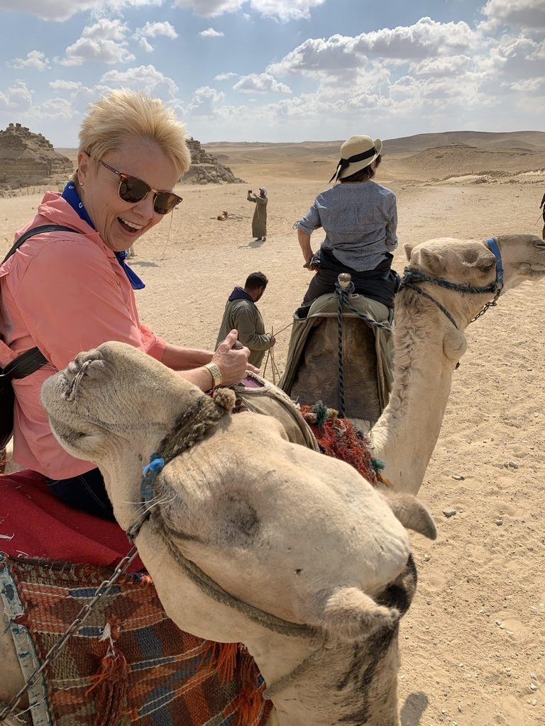 Woman in orange on camel