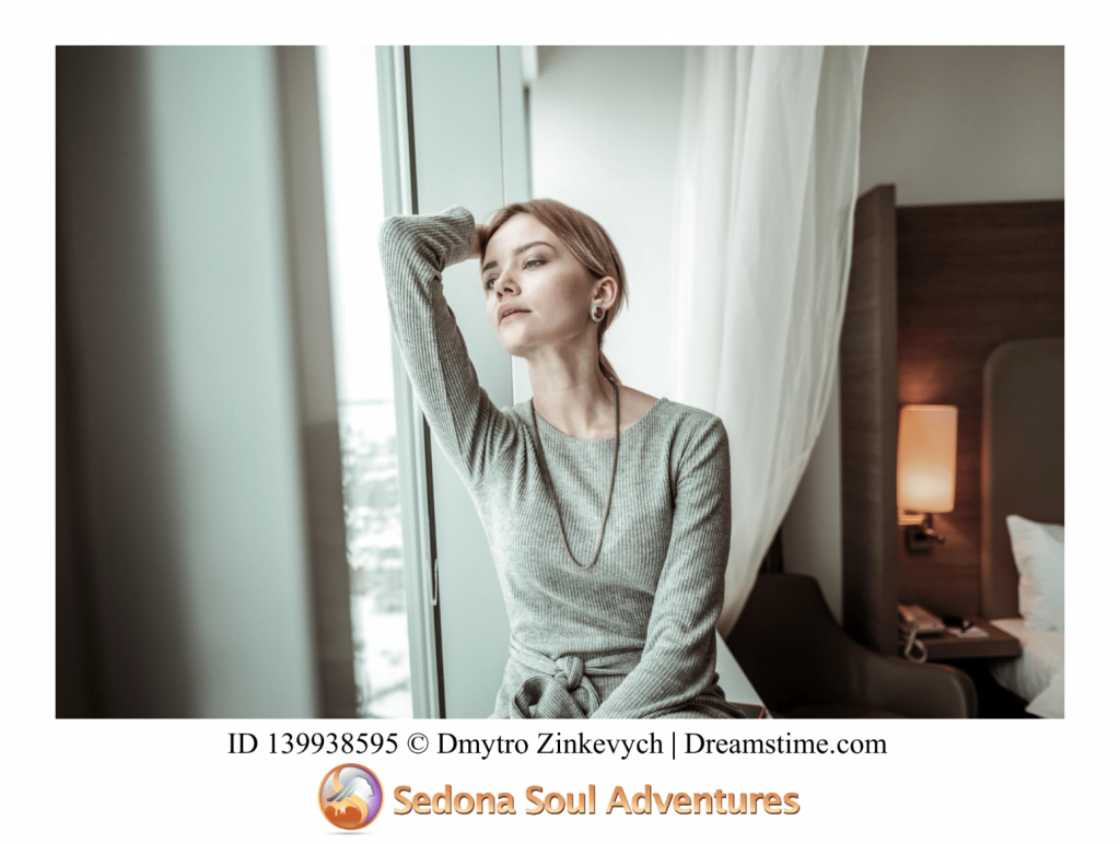 woman staring out window