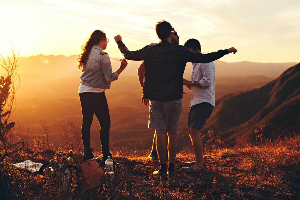 Young people in nature at sunset